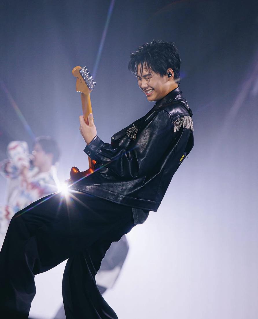 Sun playing guitar on stage at the sold-out GeminiFourth Run the World concert at Impact Arena