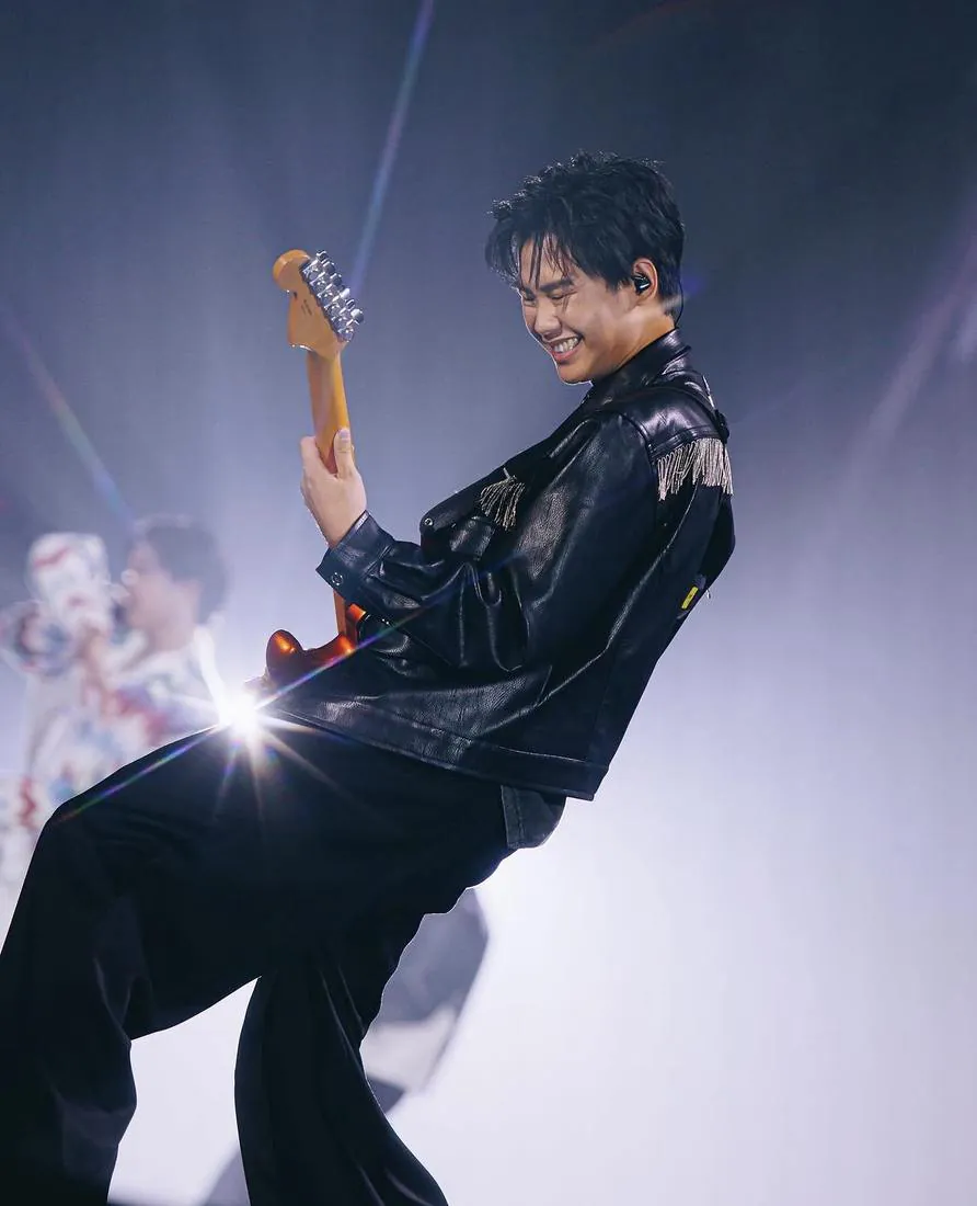 Sun playing guitar on stage at the sold-out GeminiFourth Run the World concert at Impact Arena