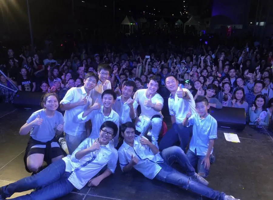 On stage at a charity concert with a full crowd