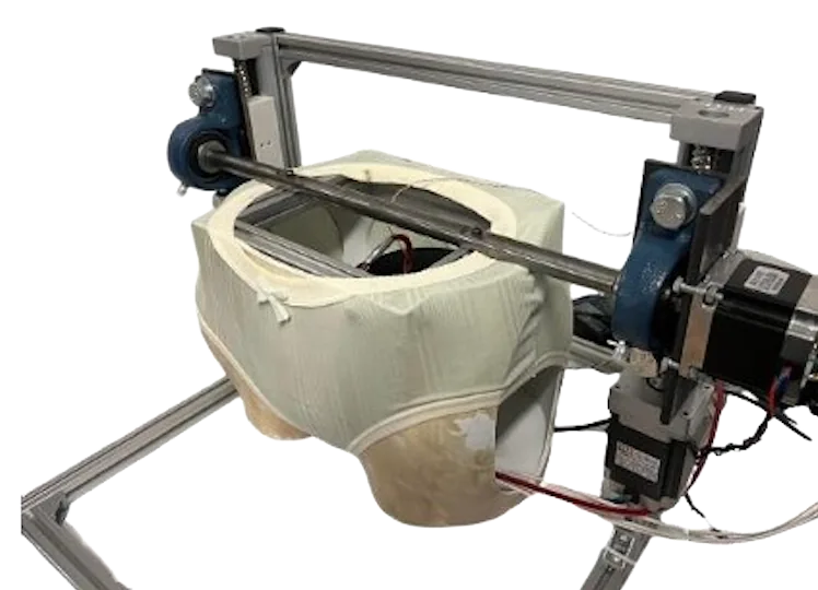 The two-degree-of-freedom menstrual product testing rig with the fabric pelvis model mounted
