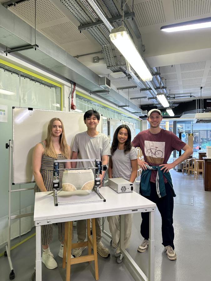 The dynamics sub-team with the rig in the workshop